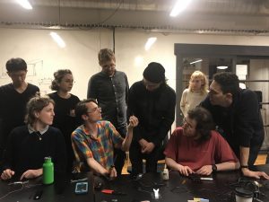 Students gathered around Ed and a soldering iron